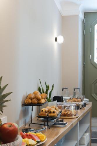 a buffet with several plates of bread and pastries at Morus Acropolis Boutique Hotel in Athens