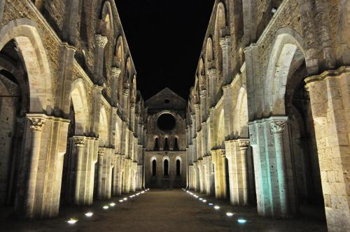 an empty hallway in a cathedral at night at Agriturismo San Galgano in Chiusdino