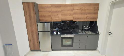 a kitchen with a stainless steel refrigerator and a stove at Tritea Apartments in Golem