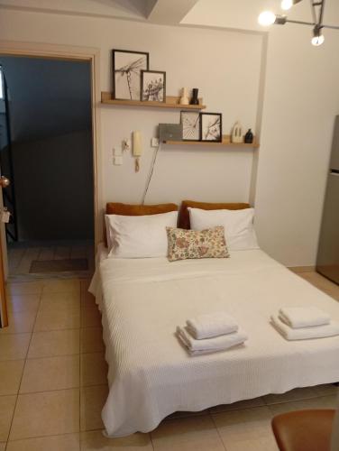 a bedroom with a bed with towels on it at Boheme and Style in Preveza