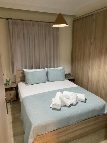 a bedroom with a large bed with towels on it at Swans Luxury Apt in Kastoria