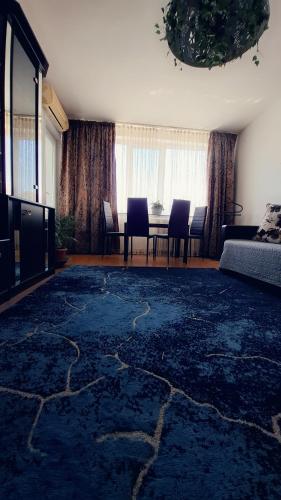 a living room with a couch and a table with chairs at Casita in Vaslui