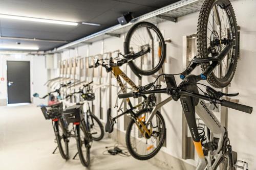 a group of bikes are hanging on a wall at Hotel Alpenhof in Grossarl