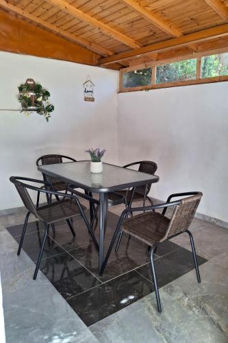 a table and chairs in a room with a ceiling at Λιόγερμα in Levidhion