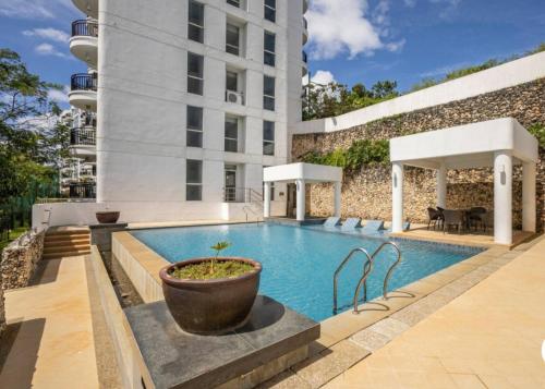 a swimming pool in front of a building at Gerbi's Condoplace at Oceanway Residences in Sampong