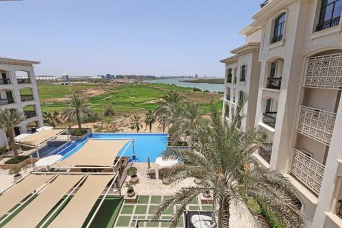an aerial view of a resort with a pool and palm trees at The Green Keepers Look-out in Abu Dhabi