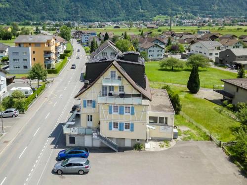a house with a car parked in front of a street at Hotel & Restaurant Rössli in Seedorf