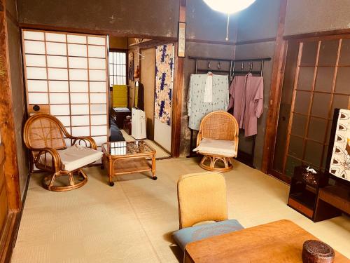 a room with chairs and a table in a room at like living in a traditional Japanese house, Accessible! one group per day! in Hirakata