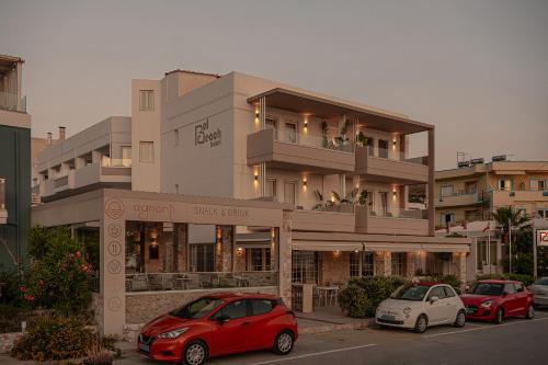 two cars parked in front of a building at Pal Beach in Palaiochóra