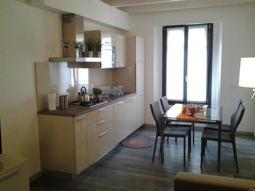 a kitchen with a table and a dining room at Como Via Carcano 13 in Como