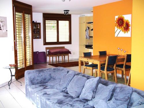 a living room with a blue couch and a table at Casa Luna by HolAp SA in Cugnasco