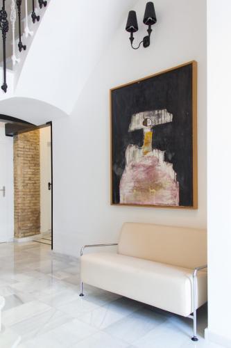 a living room with a couch and a painting on the wall at Soho Valencia in Valencia