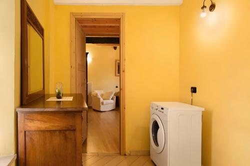 a bathroom with a washing machine and a sink at Cascina Orlandi in Costigliole dʼAsti