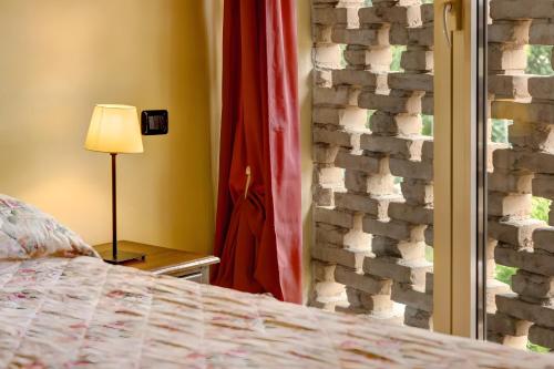 a bedroom with a bed and a stone wall at Cascina Orlandi in Costigliole dʼAsti