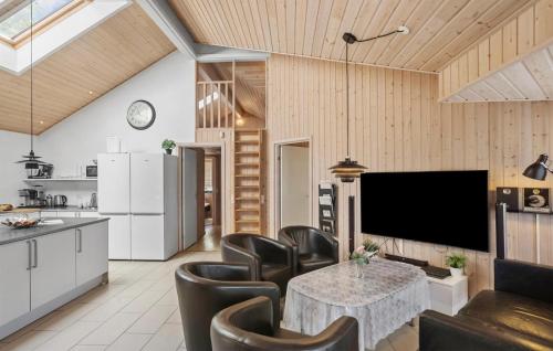 a living room with a table and leather chairs at Pet Friendly Home In Idestrup With Sauna in Marielyst