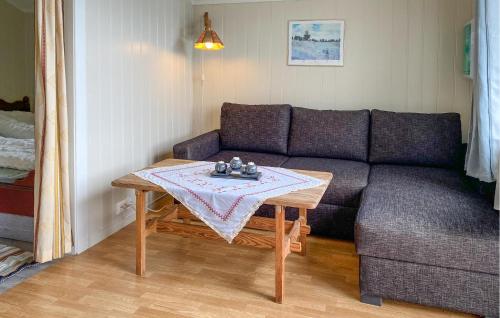 a living room with a couch and a table at 1 Bedroom Amazing Home In Tingvoll in Tingvoll