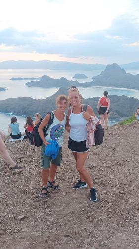 two women standing on top of a mountain at Komodo Village Tour & Homestay in Komodo