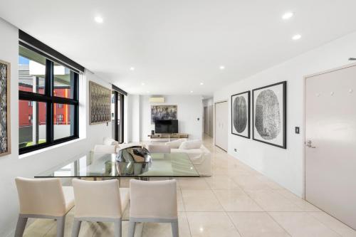a living room with a glass table and chairs at 3Bds& FishM &Citylife Super Cozy in Sydney