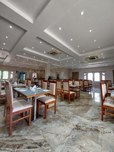 a dining room with wooden tables and chairs at Garhpanchkot Eco Tourism Unit- 2 in Garh Pānchkot