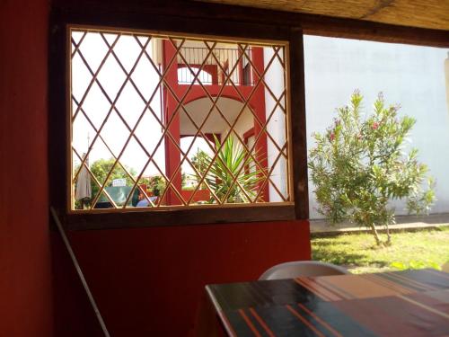 a stained glass window in a room with a table at Entula in Àrbatax