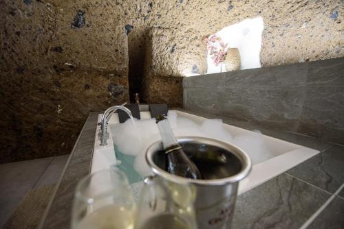a sink with a bottle in a bucket on a counter at Ortaccio relais & private SPA in Vasanello