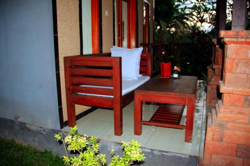 a chair and a table on a porch at Gara menjangan homestay in Banyuwedang