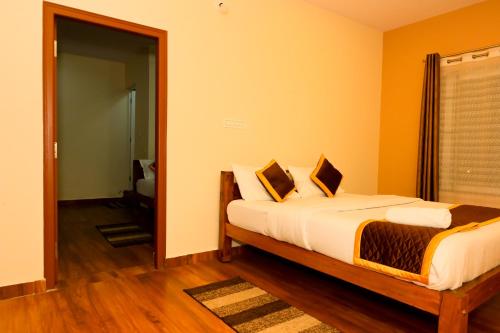 a bedroom with a bed in a room at G P Comforts in Chikmagalūr