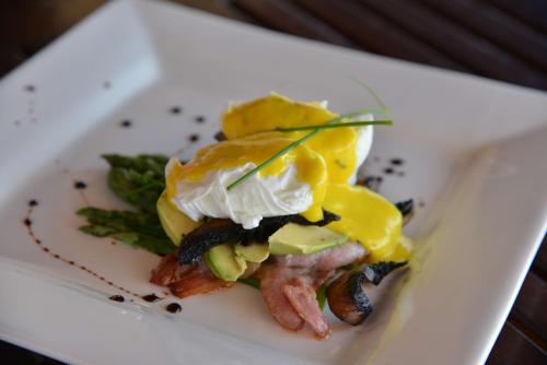 a white plate with food on top at Thakadu Bush Lodge Naka Sanga in Mabula