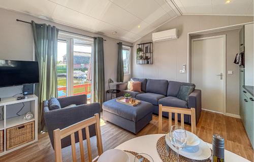a living room with a couch and a table at Nice Home In Breukelen in Breukelen