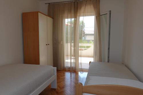 Ένα ή περισσότερα κρεβάτια σε δωμάτιο στο Apartments Nikolina