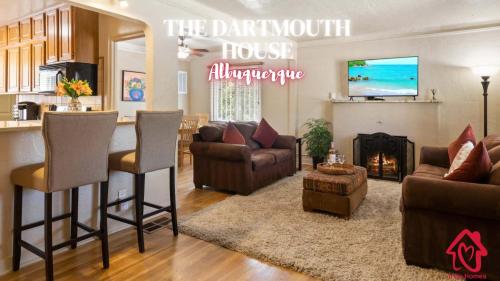 a living room with a couch and chairs and a fireplace at The Dartmouth House in Albuquerque