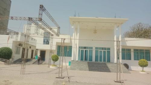 a building with a crane in front of it at Hotel Gautam Garden Lawn & Banquet Hall Near Kash Vishwanath Temple - Fully Air Conditioning Hotel in Varanasi