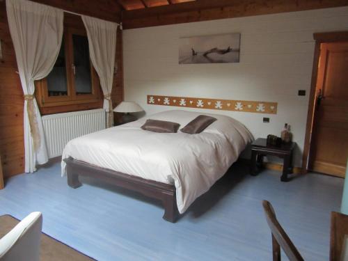 a bedroom with a large bed in a room at Les chalets de Jade in Viremont