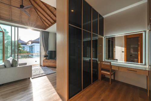 a living room with a large glass wall at V218 Brand New Near Best Beaches & Boat Avenue in Laguna Phuket