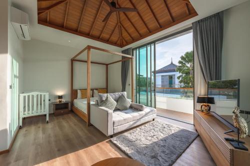 a bedroom with a bed and a large window at V218 Brand New Near Best Beaches & Boat Avenue in Laguna Phuket