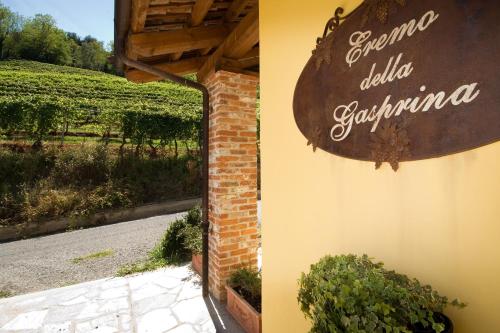a sign on the side of a building with a vineyard at Eremo della Gasprina in La Morra