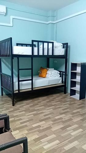 two black bunk beds in a room at Green Gen Hotel, Mueang Phuket in Phuket Town