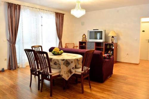 a living room with a table and a couch at Apartments M&B in Podstrana