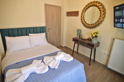 a bedroom with a bed and a table with a mirror at Sweet Retreat in Dispilio