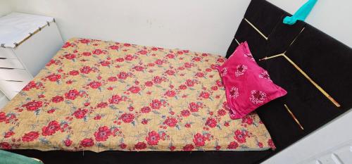 a bed with a blanket and a pillow on it at Navi House-Pond Park AL Nahda in Sabkhah