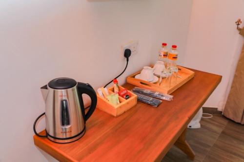 a coffee maker sitting on a wooden table at Premier Villa in Nuwara Eliya