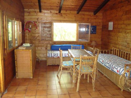 a dining room with a table and chairs in a log cabin at Serena Holiday Home in Marina di Camerota