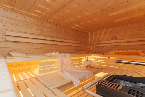 a large wooden sauna with a bed in it at Haus Bella Vista in Reit im Winkl