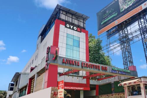 a red and white building with a building under construction at FabHotel Ajinkya Executive in Pune