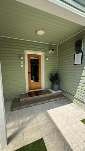 a front door of a green house with a door sidx sidx sidx at BALI House Bucharest in Bucharest