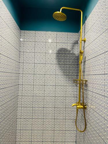 a shower with a yellow shower head in a bathroom at Cozy Retreat in Dilijan Adults Only in Dilijan