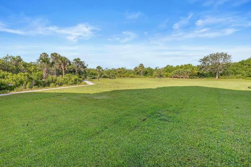 a large grassy field with a road in the distance at Oceanwalk 9-604 in New Smyrna Beach