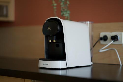 a coffeemaker sitting on a table on a counter at Le Chaleureux - 5 min Disneyland - Parking - Netflix - Wifi in Serris