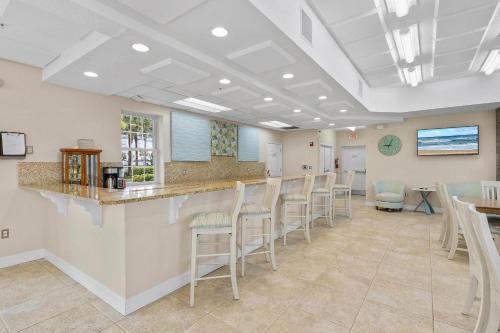 a waiting room with a counter and chairs at Oceanwalk 9-604 in New Smyrna Beach