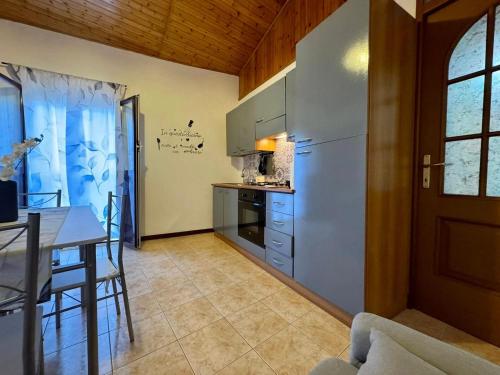 a kitchen and dining room with a table and a door at Mediterranea Apartment in Agrigento